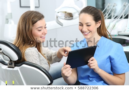 Stock fotó: Dentist And Patient Choosing Treatment In A Consultation With Medical Equipment In The Background