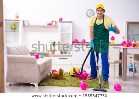 Сток-фото: Young Male Contractor Doing Housework After Party