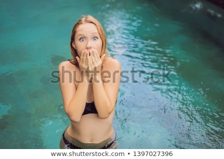 Foto d'archivio: Frustrated Young Woman Having A Bad Skin In The Pool Due To The Fact That Chemicals In The Pool