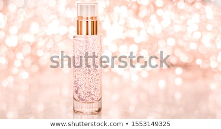 Foto d'archivio: Holiday Make Up Base Gel Serum Emulsion Lotion Bottle And Rose