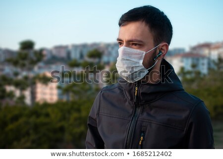 Stock foto: Isolated Young Man Wearing Mask Looking Towards In Concern