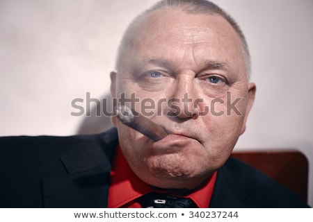 ストックフォト: A Mature Businessman Smoking A Cigare