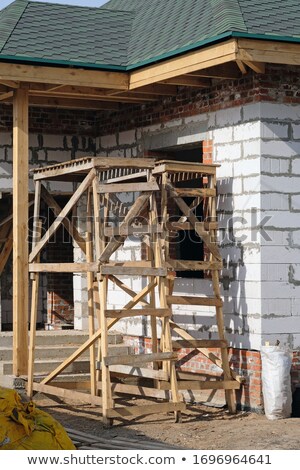 [[stock_photo]]: Old Building During Reconstruction With Wooden Scaffolding