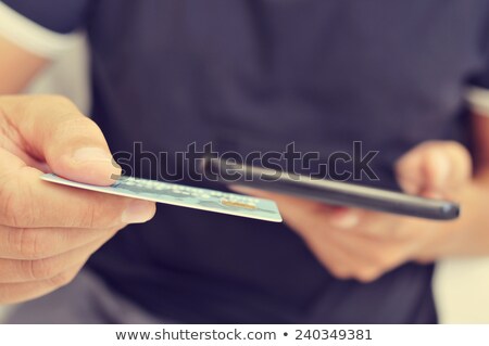 Stock photo: Young Man Shopping Online Via A Tablet Computer