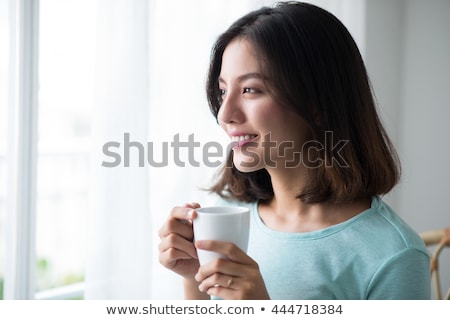 Foto stock: Beautiful Woman Drinking Tea In Dark Room