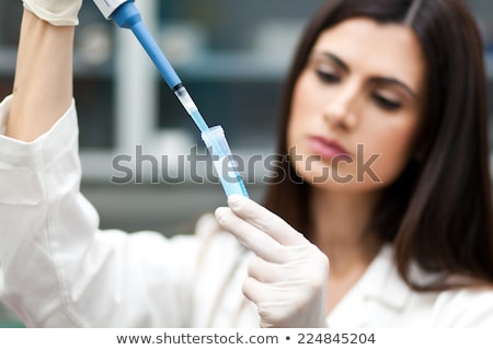 [[stock_photo]]: Close Up Of Scientists Filling Test Tube In Lab