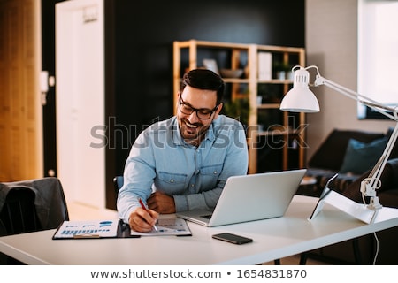 Foto stock: Handsome Young Man Working From Home Office