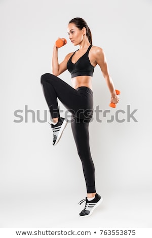 Stock fotó: Young Sporty Woman Doing Exercises Over White