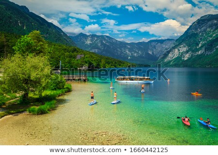 Foto stock: Man Rowing Boat On Lake Bohinj