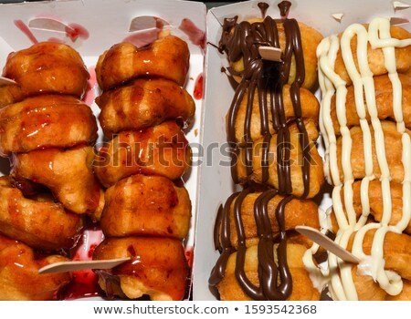 Stockfoto: Delicious Donut With Chocolate Icing And Sprinkles