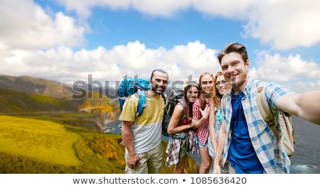 Stock fotó: Smiling Woman With Backpack Over Big Sur Hills