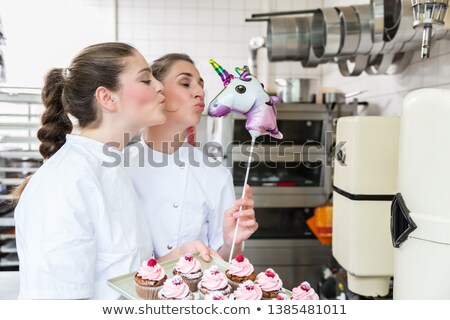 Foto stock: Two Pastry Bakers Playing With Toys And Cakes