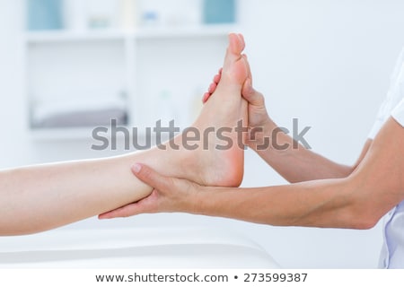 [[stock_photo]]: Physiotherapist Doing Foot Massage In Clinic