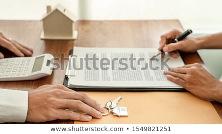 Foto stock: Real Estate Developer Agent And Sign On Document Giving Keys Of