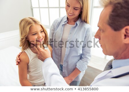Stok fotoğraf: Beautiful Doctor Taking The Pulse Of Her Patient At Her Office