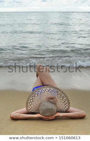 Stok fotoğraf: Young Woman Sun Bathing On A Sandy Beach Of Thailand