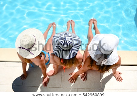 Stock fotó: Three Girls Sitting On Swimming Pool In Summer Relaxing