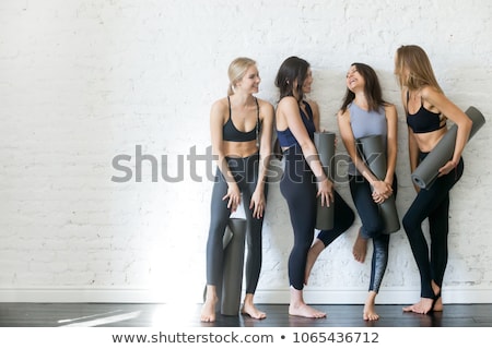 Foto stock: Excited Pilates Girl With Yoga Mat Standing