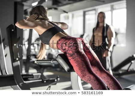 Stockfoto: Sportive Girl Does Exercise In Gym