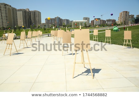 Stockfoto: Wooden Easel With A White Canvas On The Street