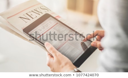 Foto stock: Woman Reading Online News On Digital Tablet