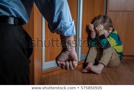 Stok fotoğraf: Boy Sitting Alone Leaning On The Wall With The Father Fist