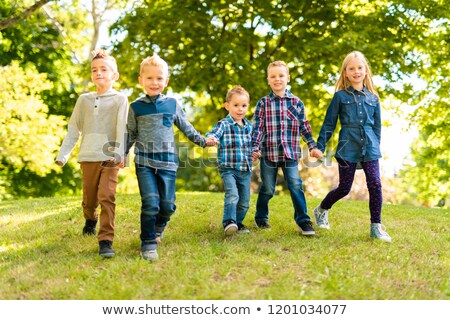 Stok fotoğraf: A Group Of Children In Spring Field Having Fun