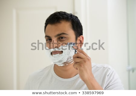 Foto stock: Indian Man Shaving Beard With Razor Blade