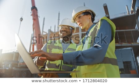 Foto stock: Project Developer And Construction Worker On Site Using Technology