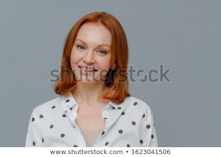 Stock photo: Elegant Redhead Woman Looks At Camera With Gentle Toothy Smile Has Healthy Freckled Skin Happy To