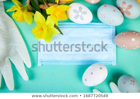 ストックフォト: Easter Symbol Eggs Near Protective Medical Masks Due To Coronavirus Epidemic