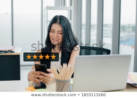 Foto d'archivio: Smiling Female Executive Using A Mobile In The Office