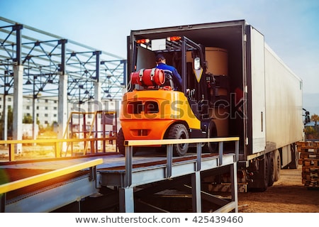 [[stock_photo]]: Forklift Truck Loads Pallet On The Rack