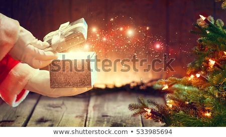 Stockfoto: Santa Claus Opening Giving Xmas Present