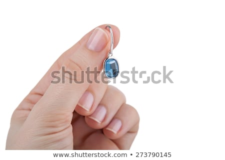 Stockfoto: Female Hand Holding A Sapphire Earring