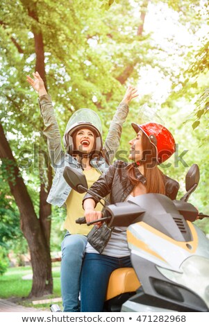 Zdjęcia stock: Laughing Couple Riding On A Scooter