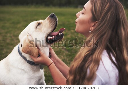 Foto stock: Happy Attractive Young Woman Smiling And Running With Dog