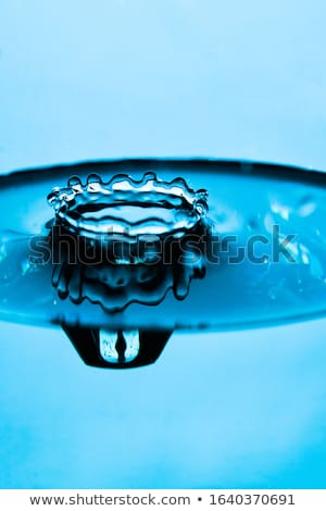 Stockfoto: Water Drop Falling Into Water Surface