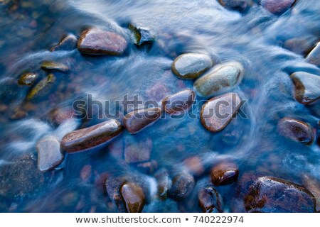 [[stock_photo]]: Rock Sculpture Of Arrow Symbol In River