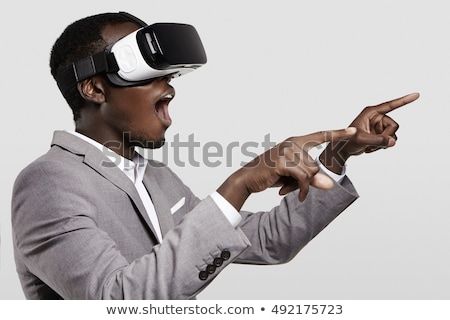 Stock photo: Businessman Pointing His Finger While Using Virtual Reality Headset