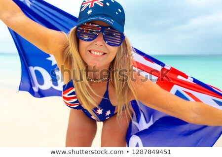 Zdjęcia stock: Smiling Female Holding Australian Flag And Wearing Flag Bikini