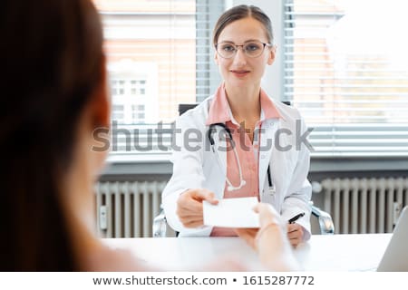 Foto stock: Doctor Handing Slip For Prescription Drug Over To Patient