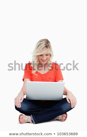 [[stock_photo]]: Attractive Fair Haired Woman Sitting Cross Legged While Looking At Her Laptop