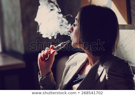 Foto d'archivio: Woman Smoking With Electronic Cigarette