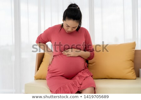 Stock photo: Woman Suffering Back Ache Or Pain