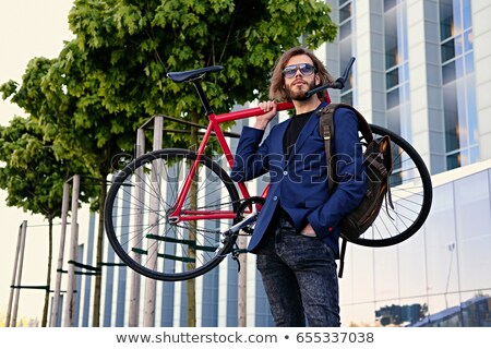 Foto stock: Man With Red Beard And Sunglasses Fixing His Hair