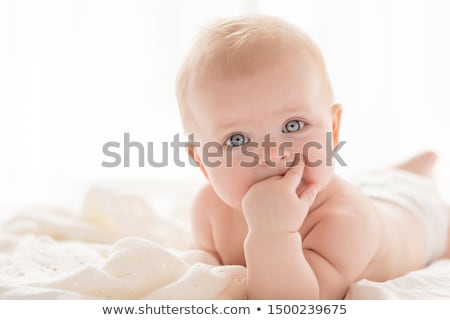 Foto stock: Beautiful Blond Girl Sitting On Sun Bed