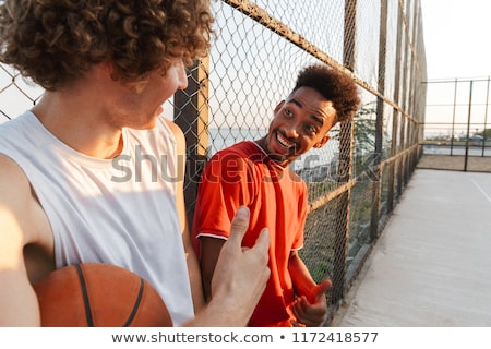 Foto stock: Two Young Cheerful Multiethnic Men Basketball Players