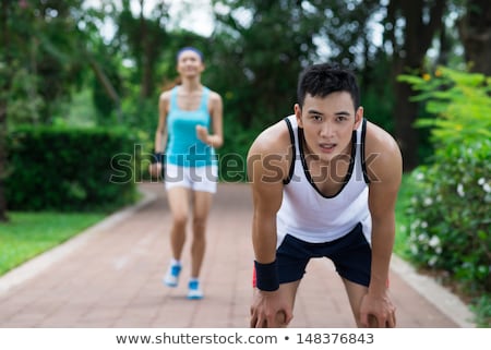 Stock photo: Focused Young Asian Man Jogging At The Park
