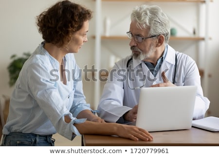 Foto stock: Doctor Explaining For Patient And Showing Medical Records Inform